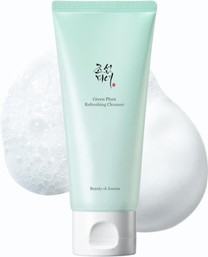Green facial cleanser with a white applicator on a light gray background