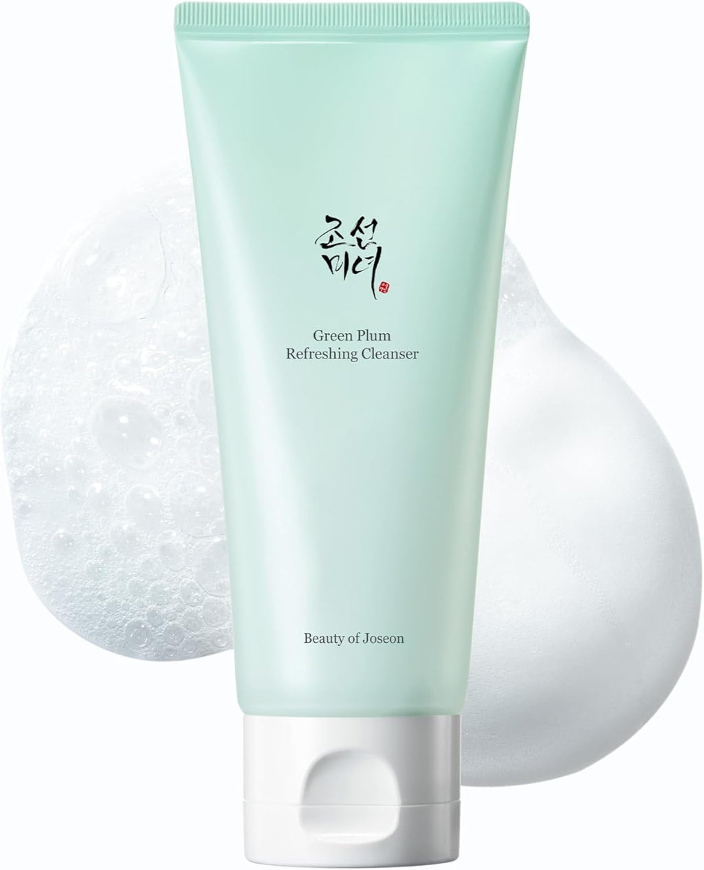 Green facial cleanser with a white applicator on a light gray background