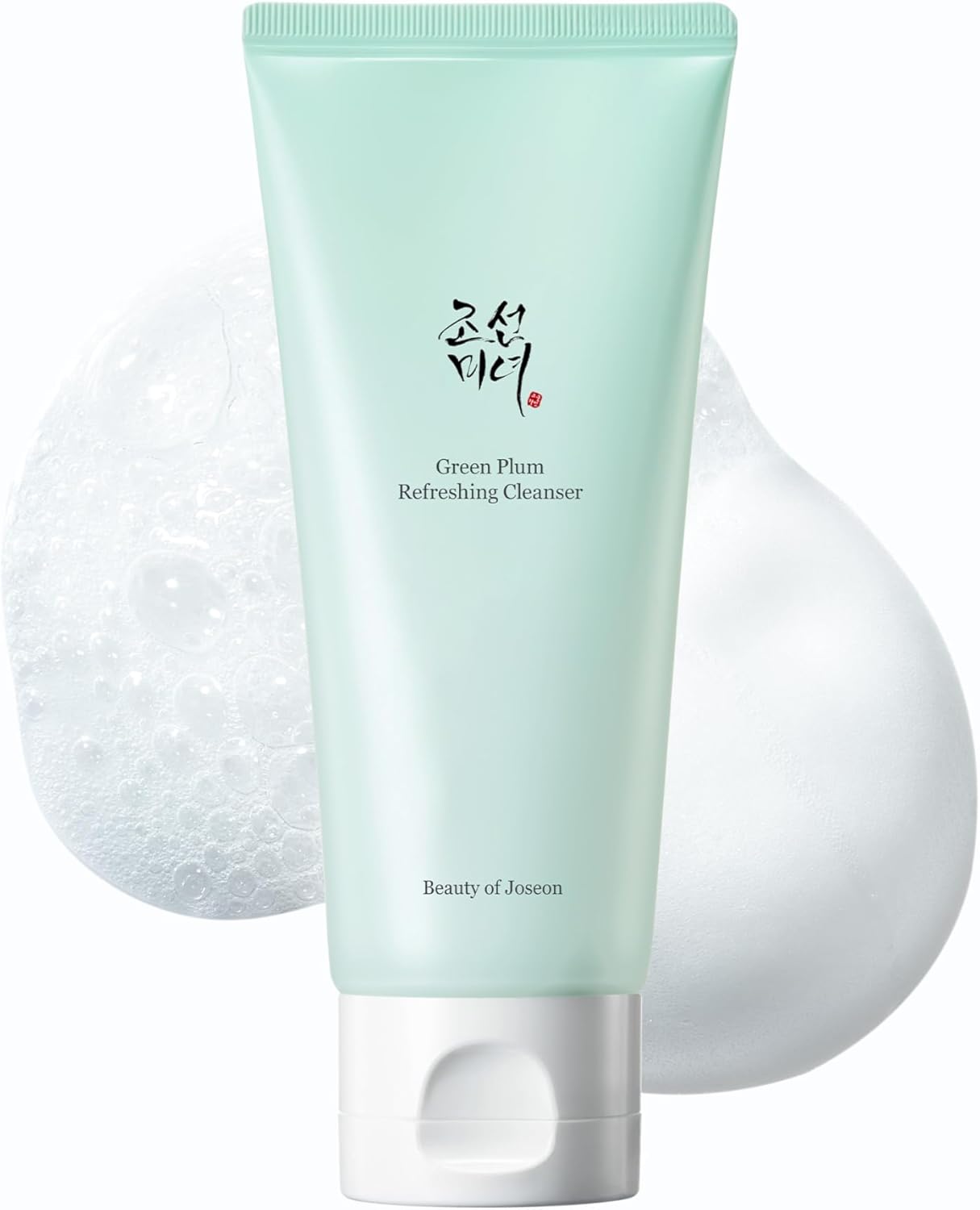 Green facial cleanser with a white applicator on a light gray background