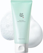 Green facial cleanser with a white applicator on a light gray background