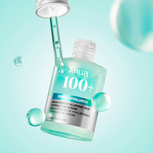 Anua 100+ serum bottle with dropper on a light blue background